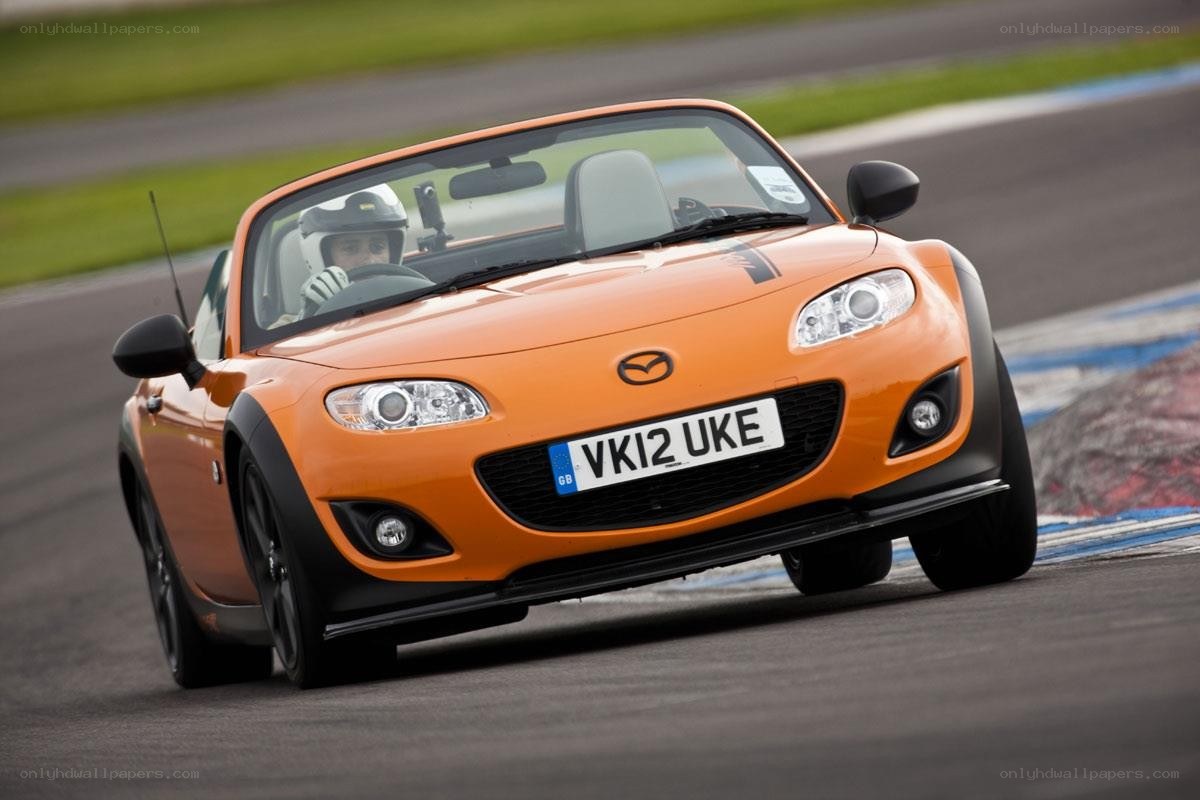 Orange Mazda MX-5 on a racetrack