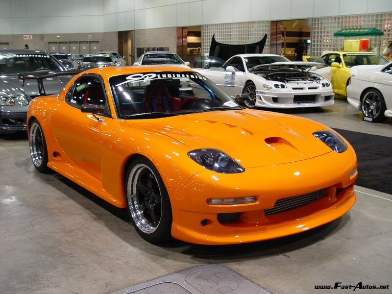 Orange Mazda RX-7 at car show