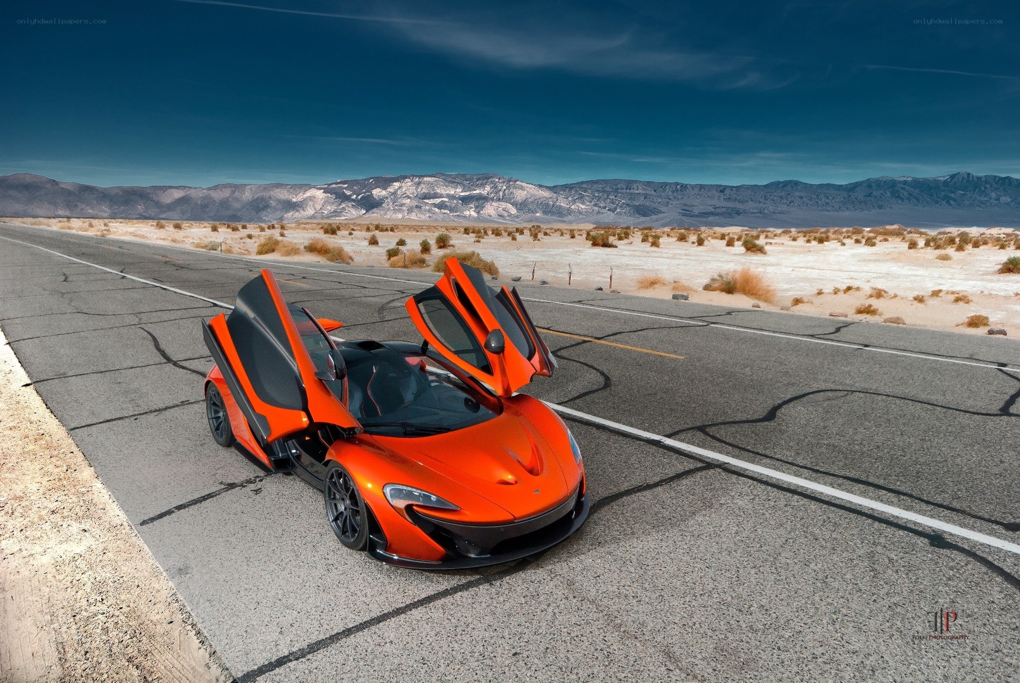 Orange McLaren in desert landscape