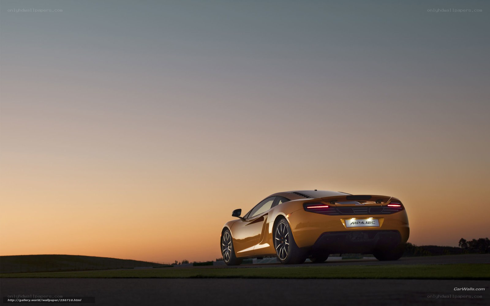 Orange McLaren MP4-12C at sunset