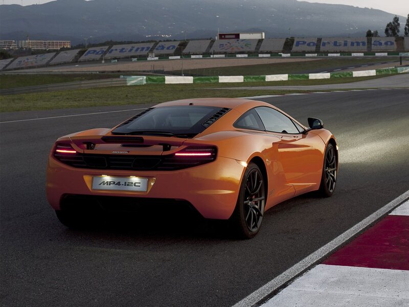 Orange McLaren MP4-12C on a racetrack
