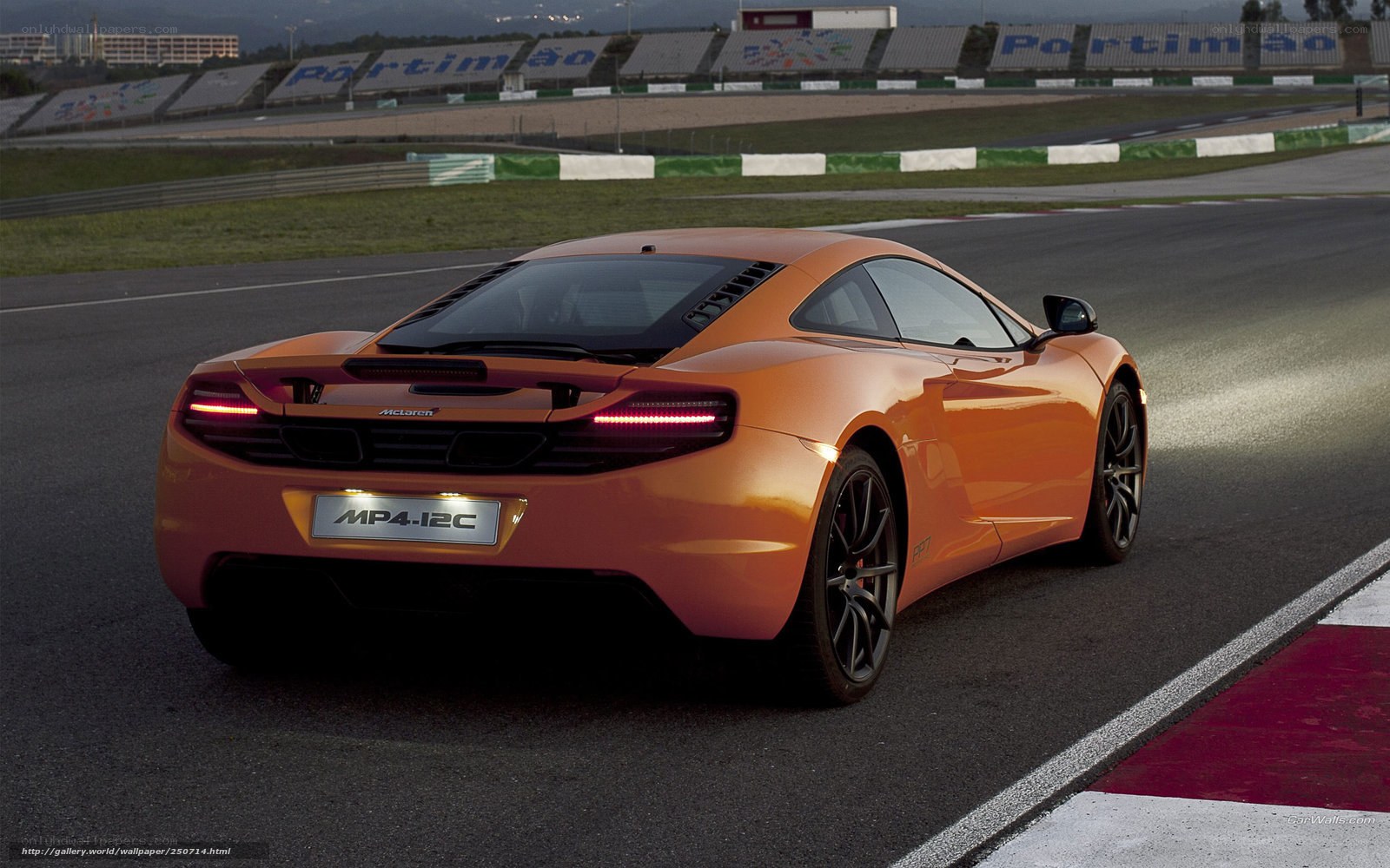 Orange McLaren MP4-12C on racetrack