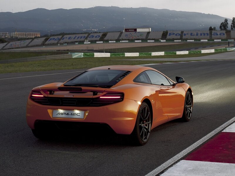 Orange McLaren MP4-12C on track