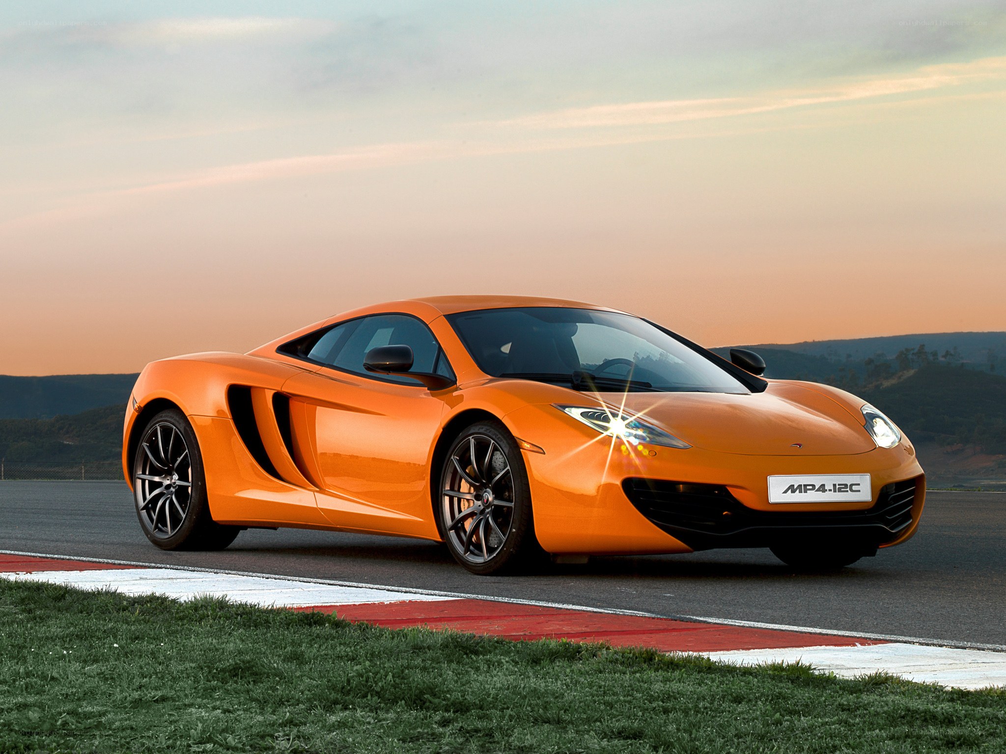 Orange McLaren MP4-12C on track
