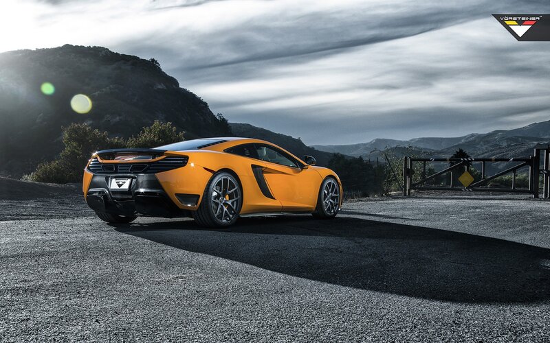 Orange McLaren on a mountain road