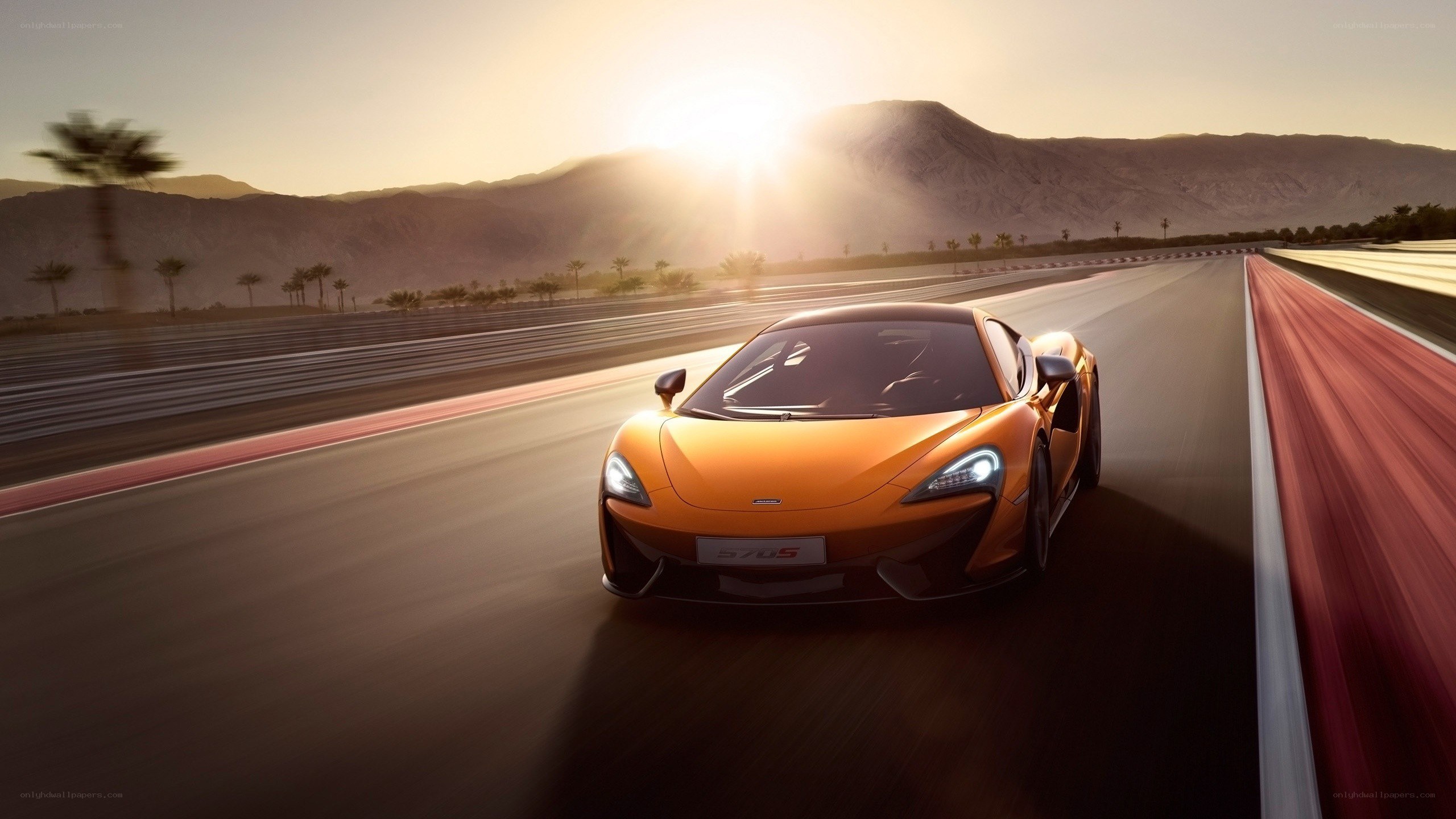Orange McLaren on a racetrack