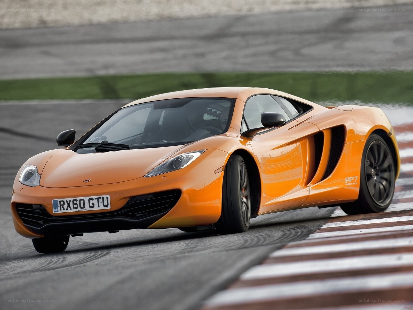 Orange McLaren on a racetrack