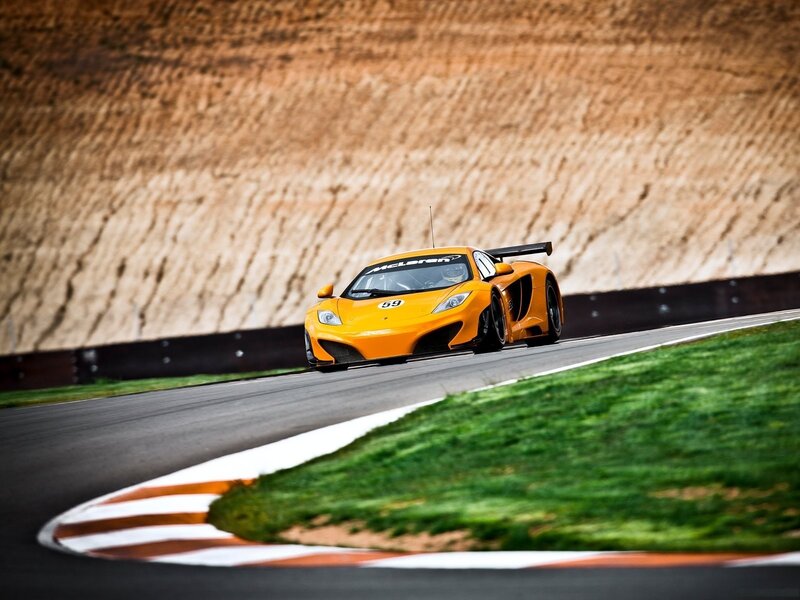 Orange McLaren on a racetrack