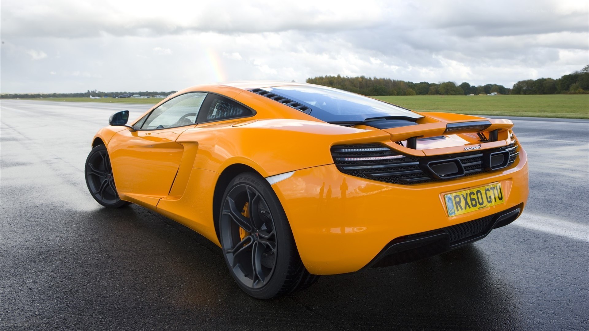 orange McLaren on a runway