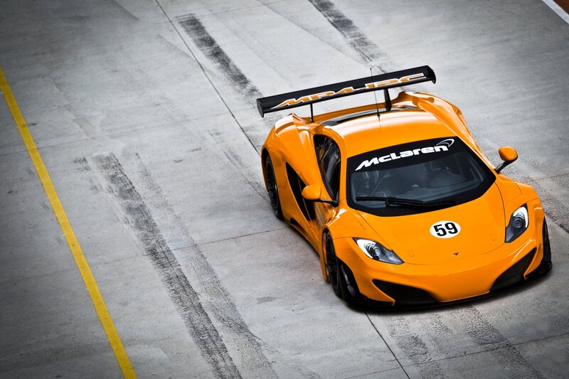 Orange McLaren race car on track