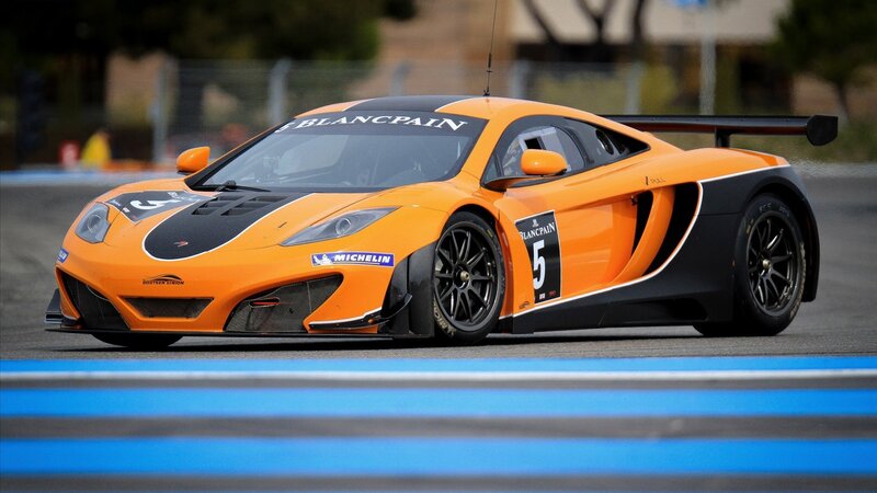 Orange McLaren race car on track