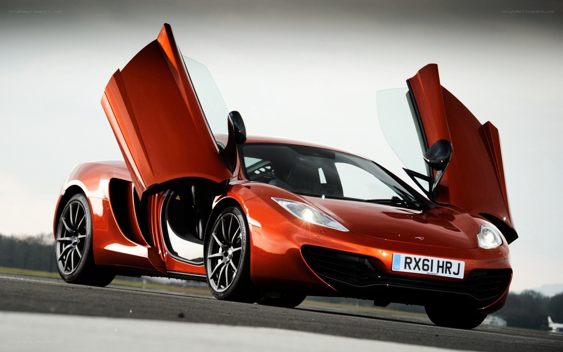 Orange McLaren with doors open