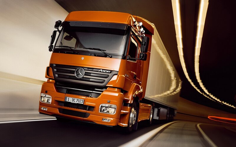 Orange Mercedes-Benz truck in tunnel