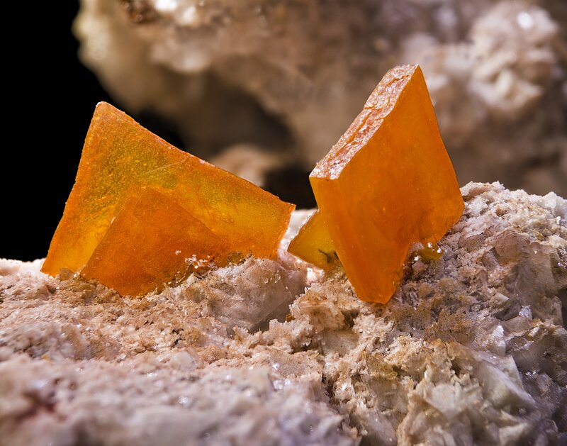 Orange mineral crystals on rock
