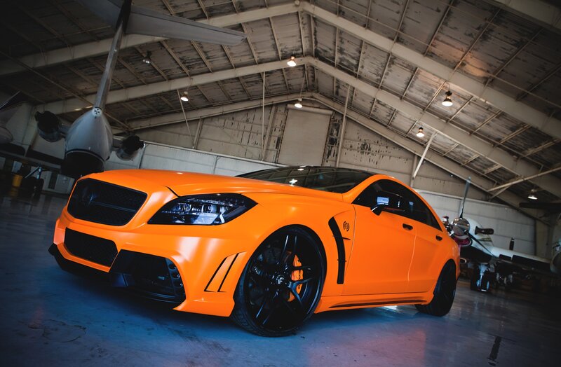 Orange Modified Car — Dramatic, Photograph, Airplane, Hangar, Black Wheels, Black