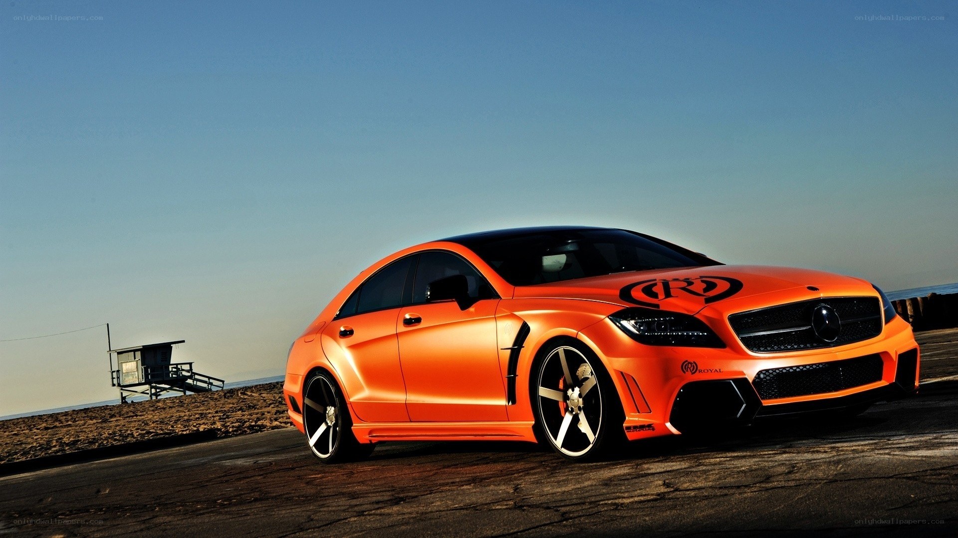 orange modified car on beach