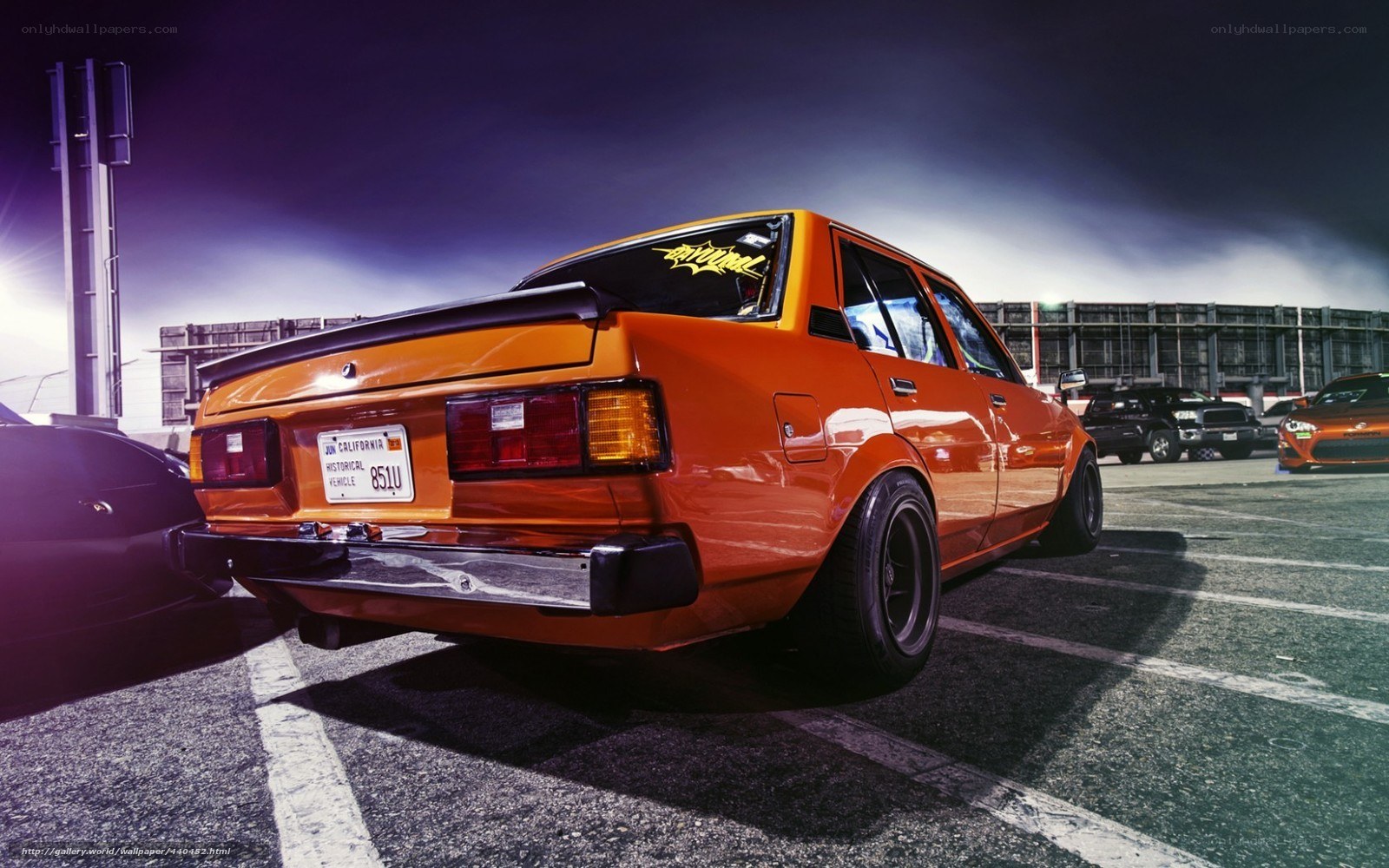 Orange modified sedan at night