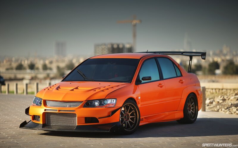 Orange Modified Sedan — Dramatic, Afternoon, Photograph, City Skyline, Crane, Tarmac