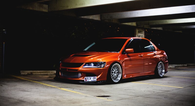 Orange Modified Sedan — Dramatic, Night, Photograph, Car, Parking Garage