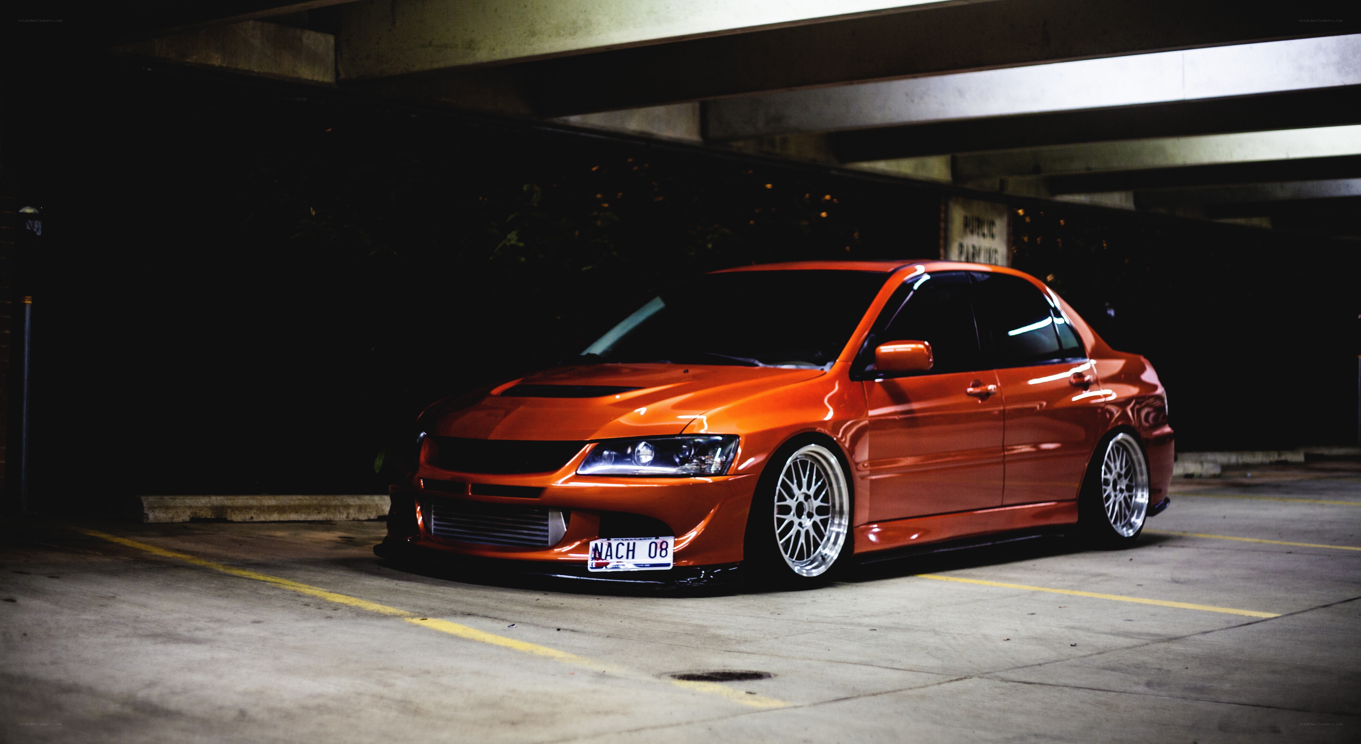 orange modified sedan in garage
