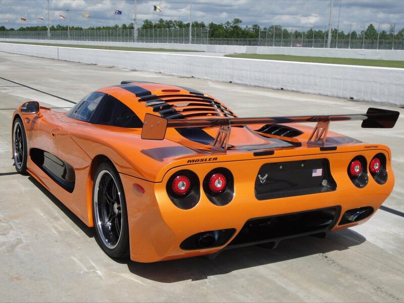 Orange Mosler sports car on track