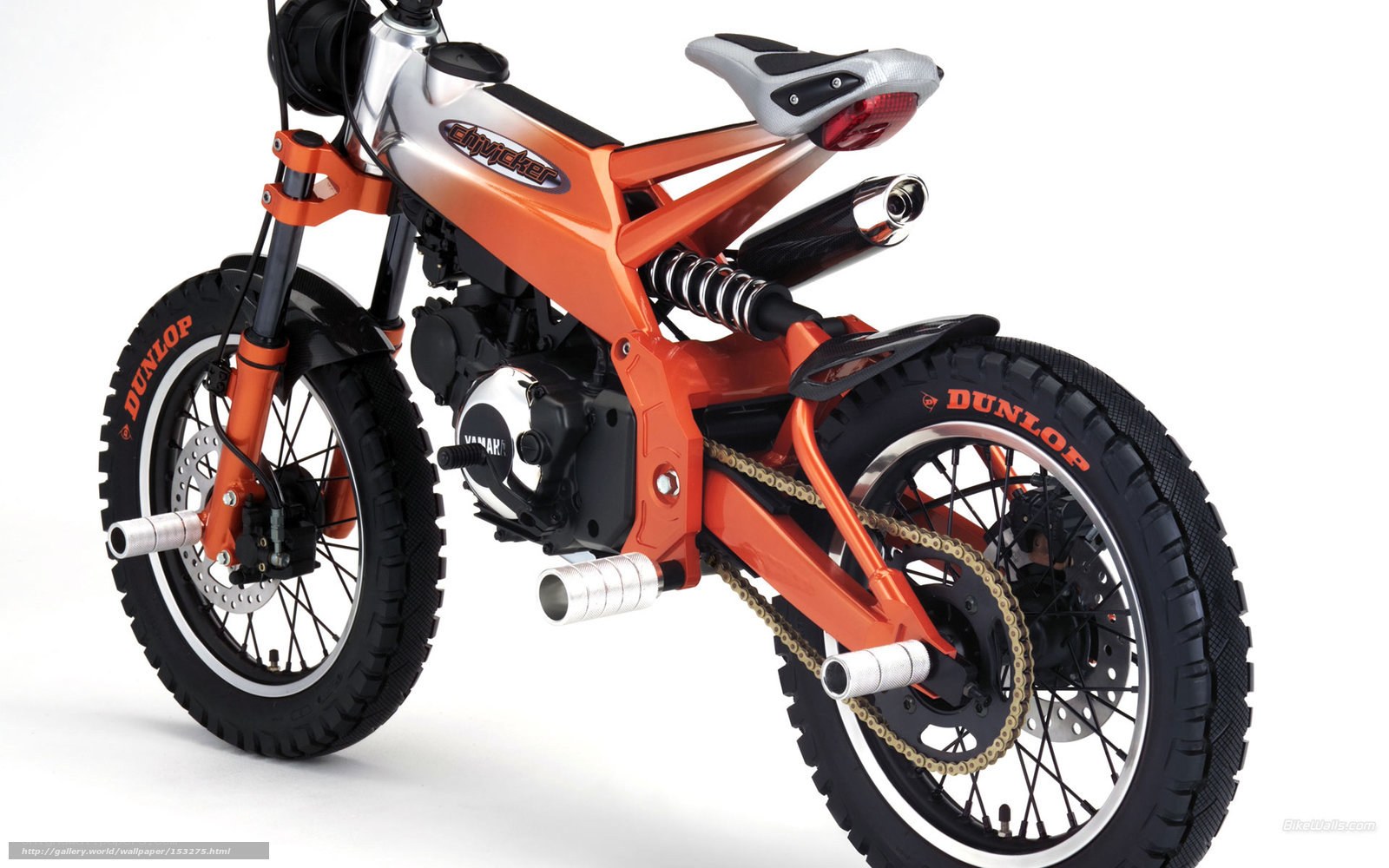 orange motorbike with Dunlop tires