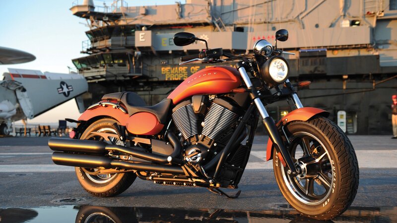 Orange Motorcycle on Deck — Dramatic, Sunset