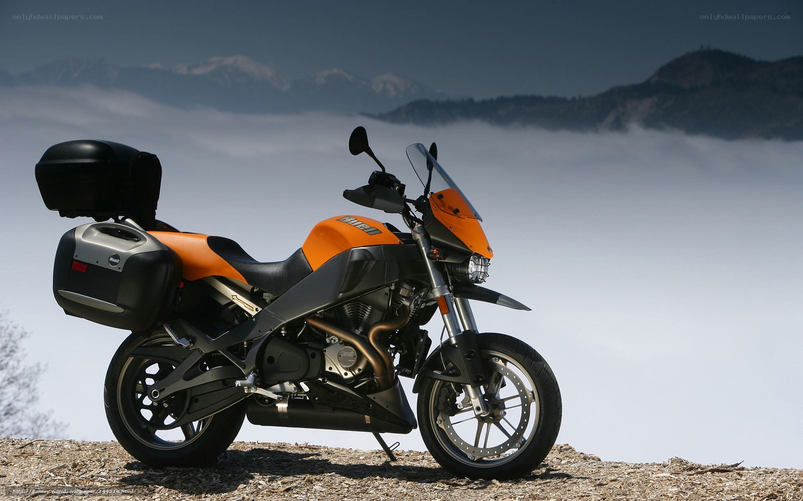 Orange motorcycle on mountain peak