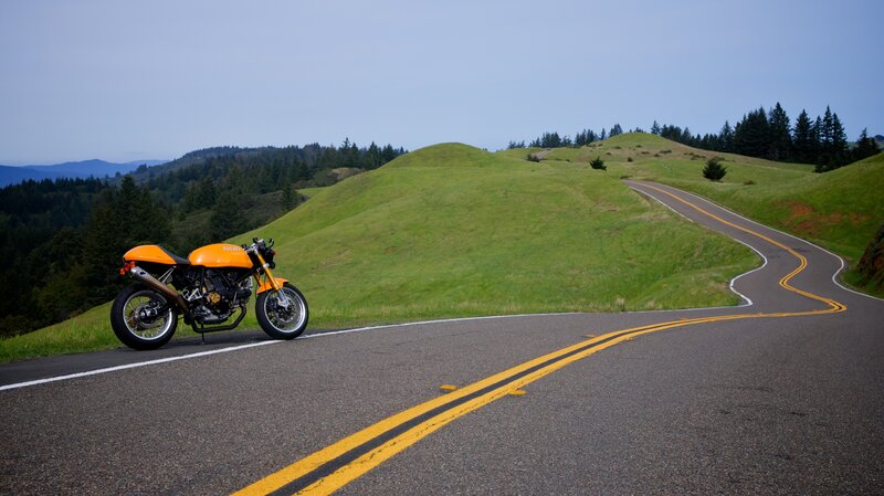 Orange motorcycle on winding road