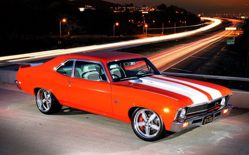 Orange muscle car at night