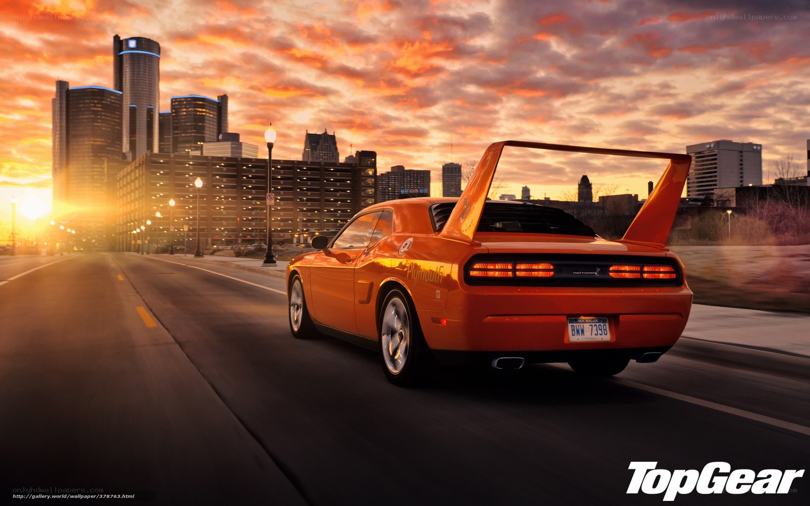 Orange muscle car at sunset