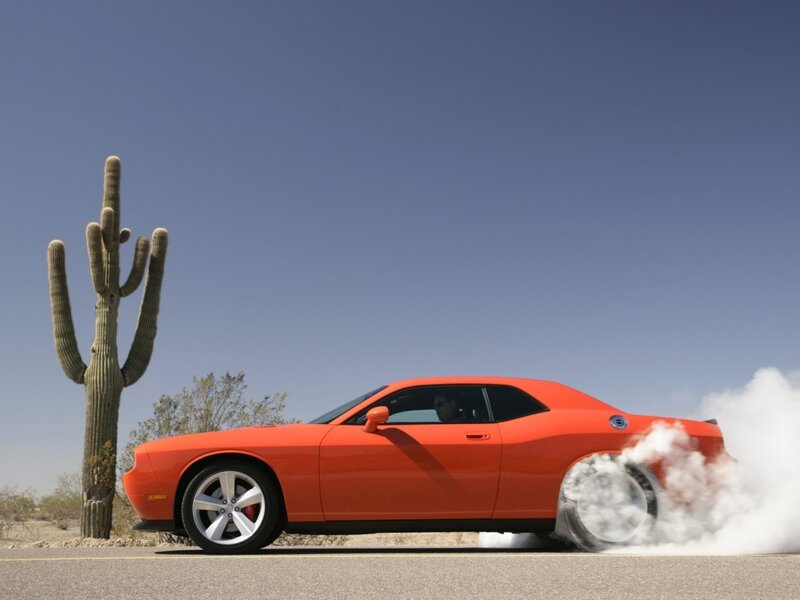 Orange muscle car doing burnout