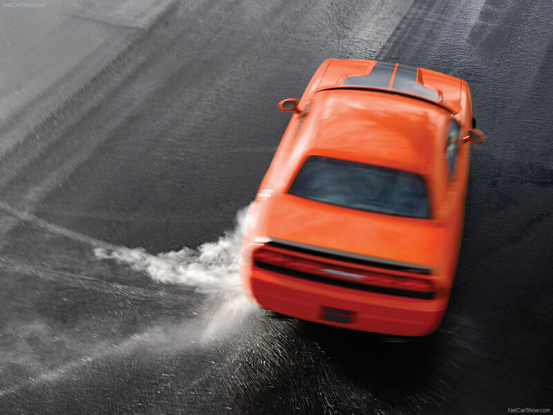 orange muscle car drifting