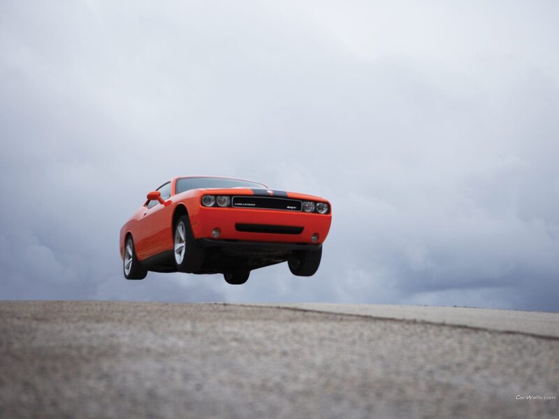 Orange muscle car in mid-air