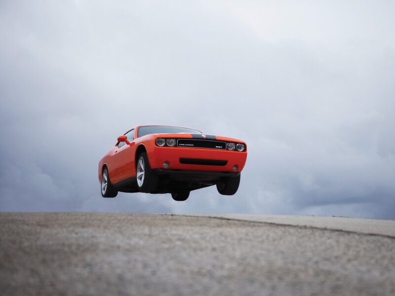 Orange muscle car in mid-air