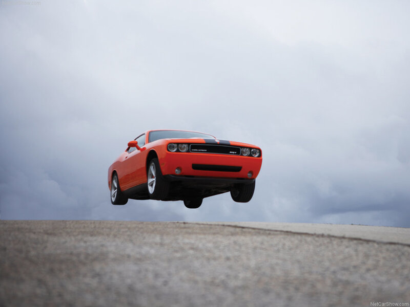 Orange muscle car in mid-air