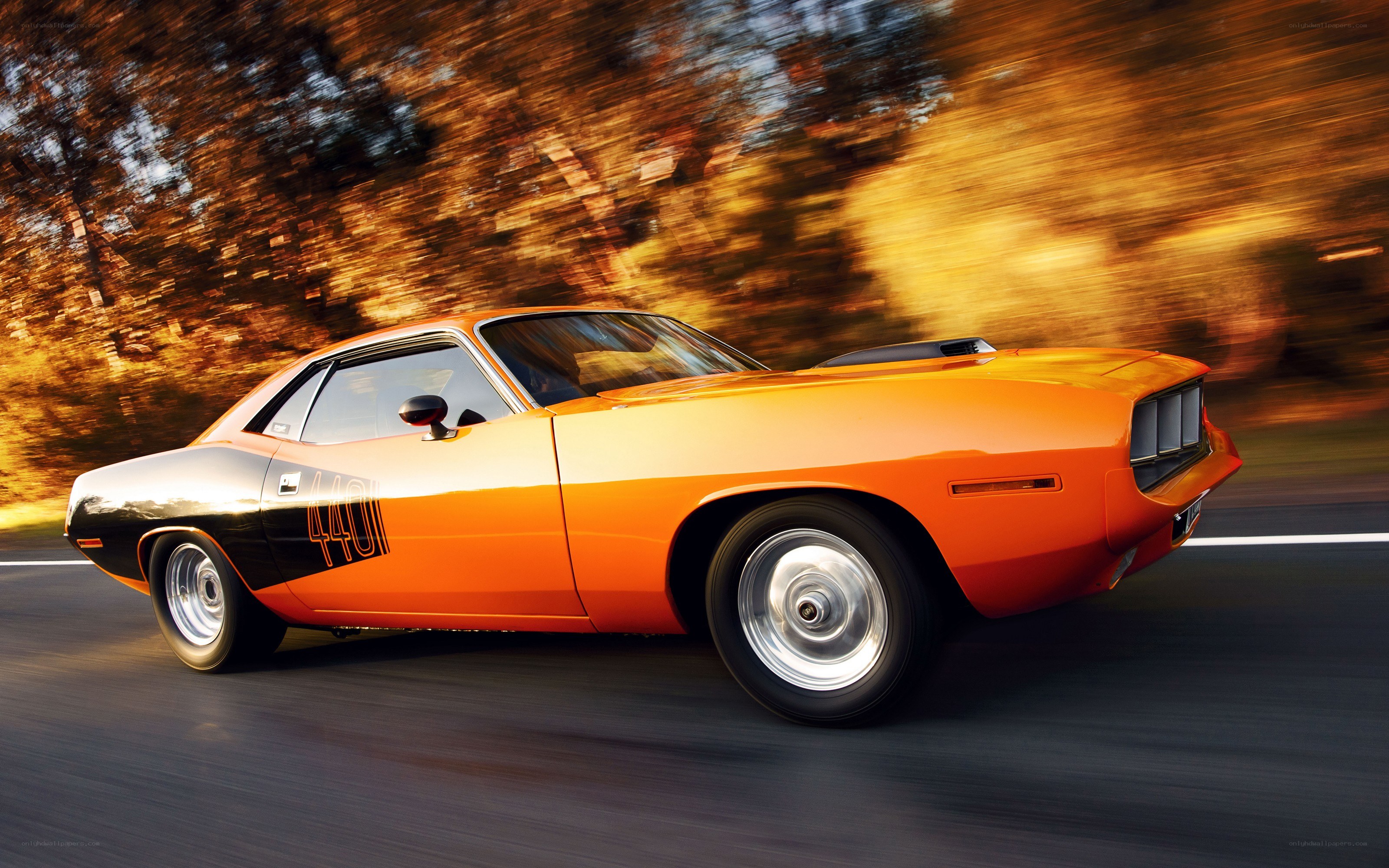 Orange muscle car in motion