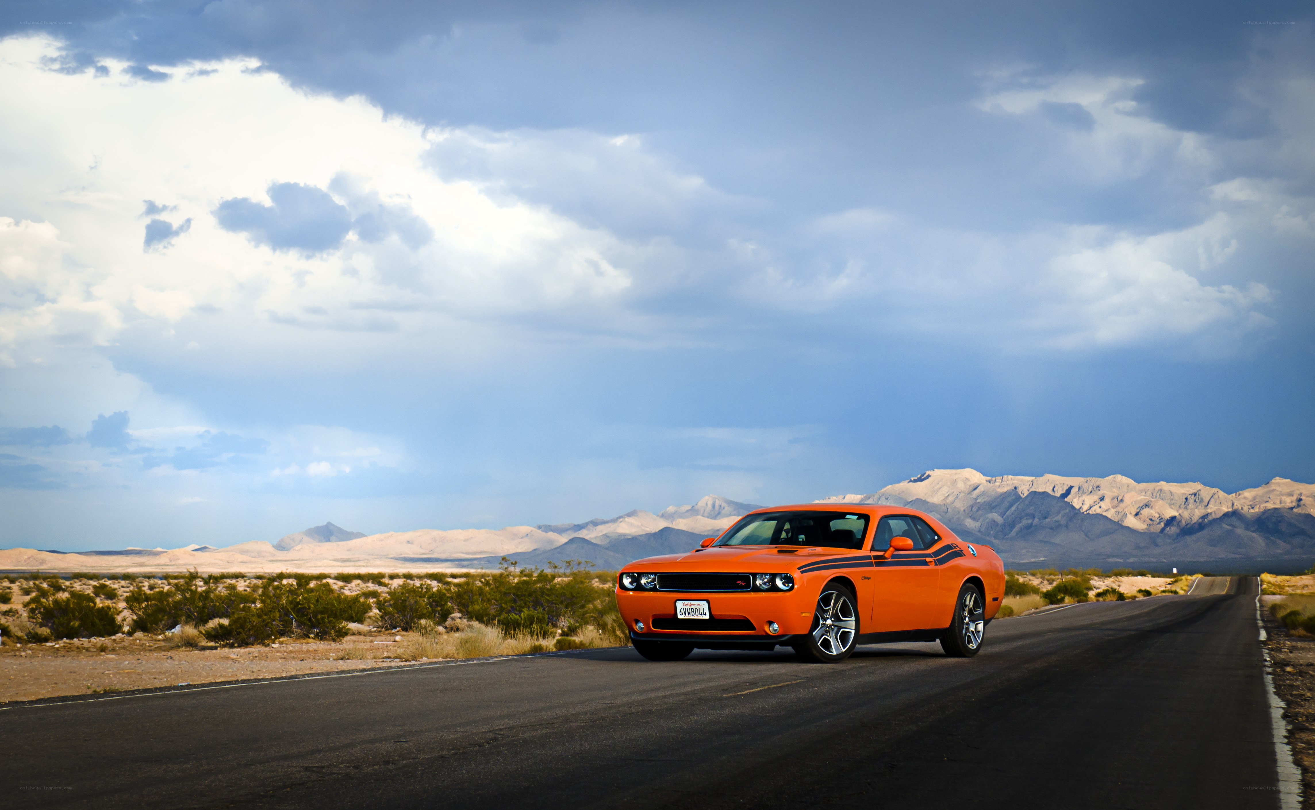 Orange muscle car on desert road