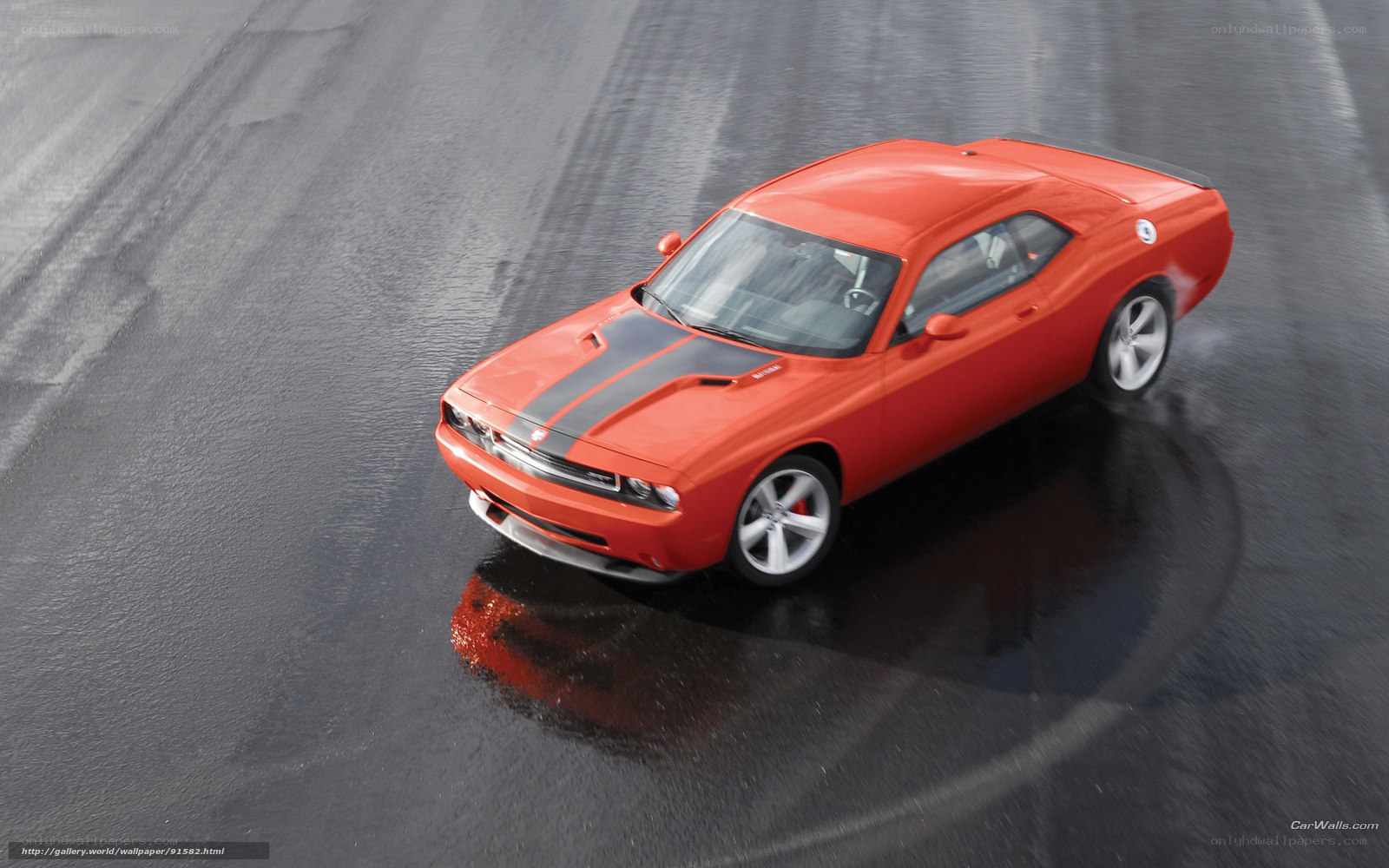 Orange muscle car on wet pavement