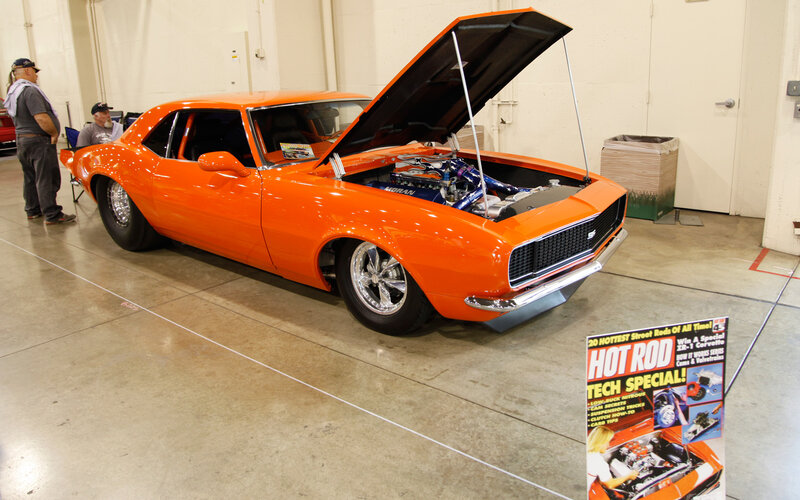 Orange Muscle Car — Showroom, Photograph, People
