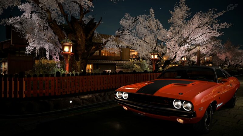 Orange muscle car under cherry blossoms
