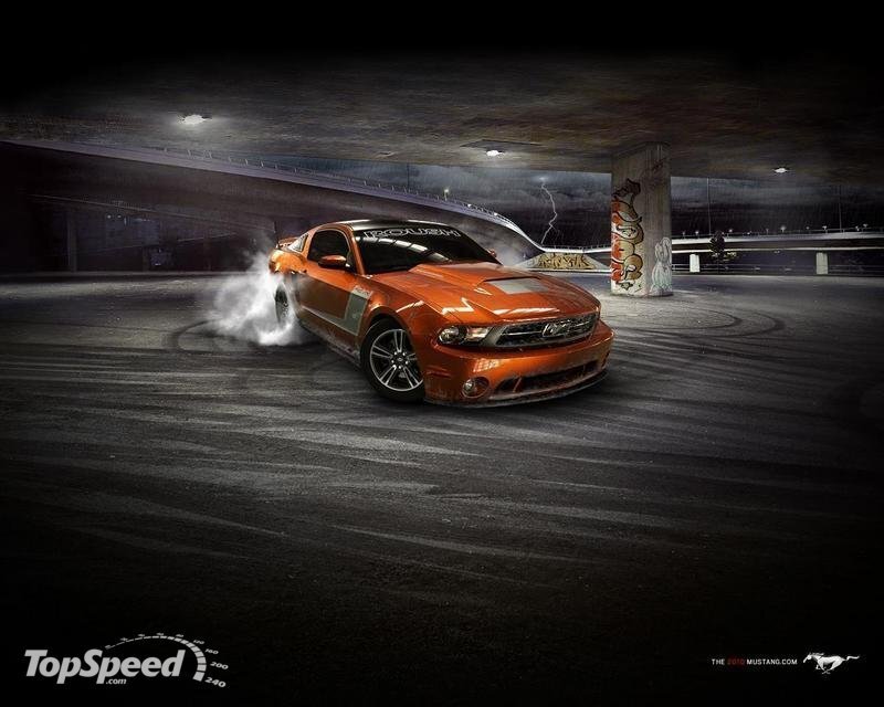 Orange Mustang drifting at night
