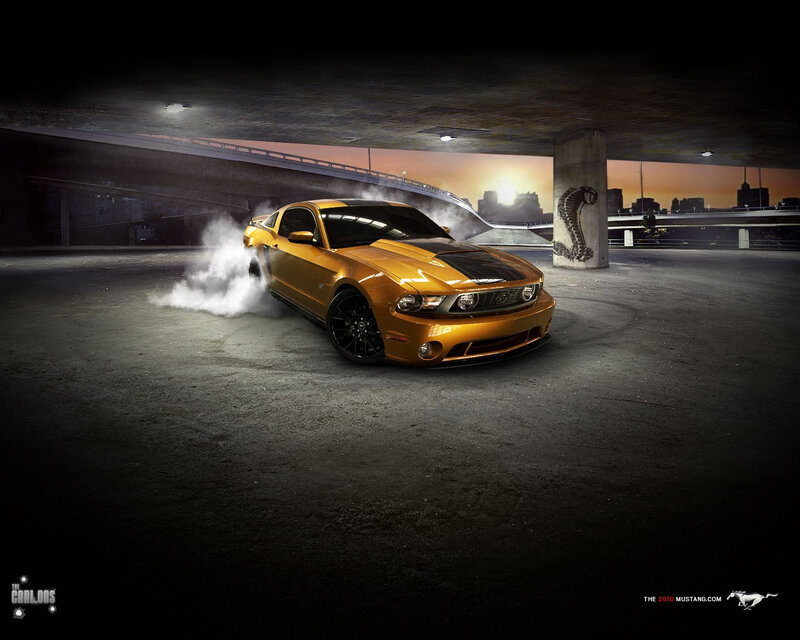 Orange Mustang drifts at night