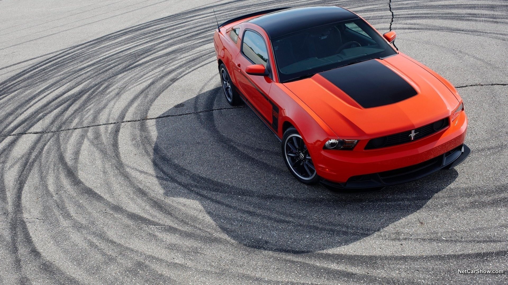 orange mustang on racetrack