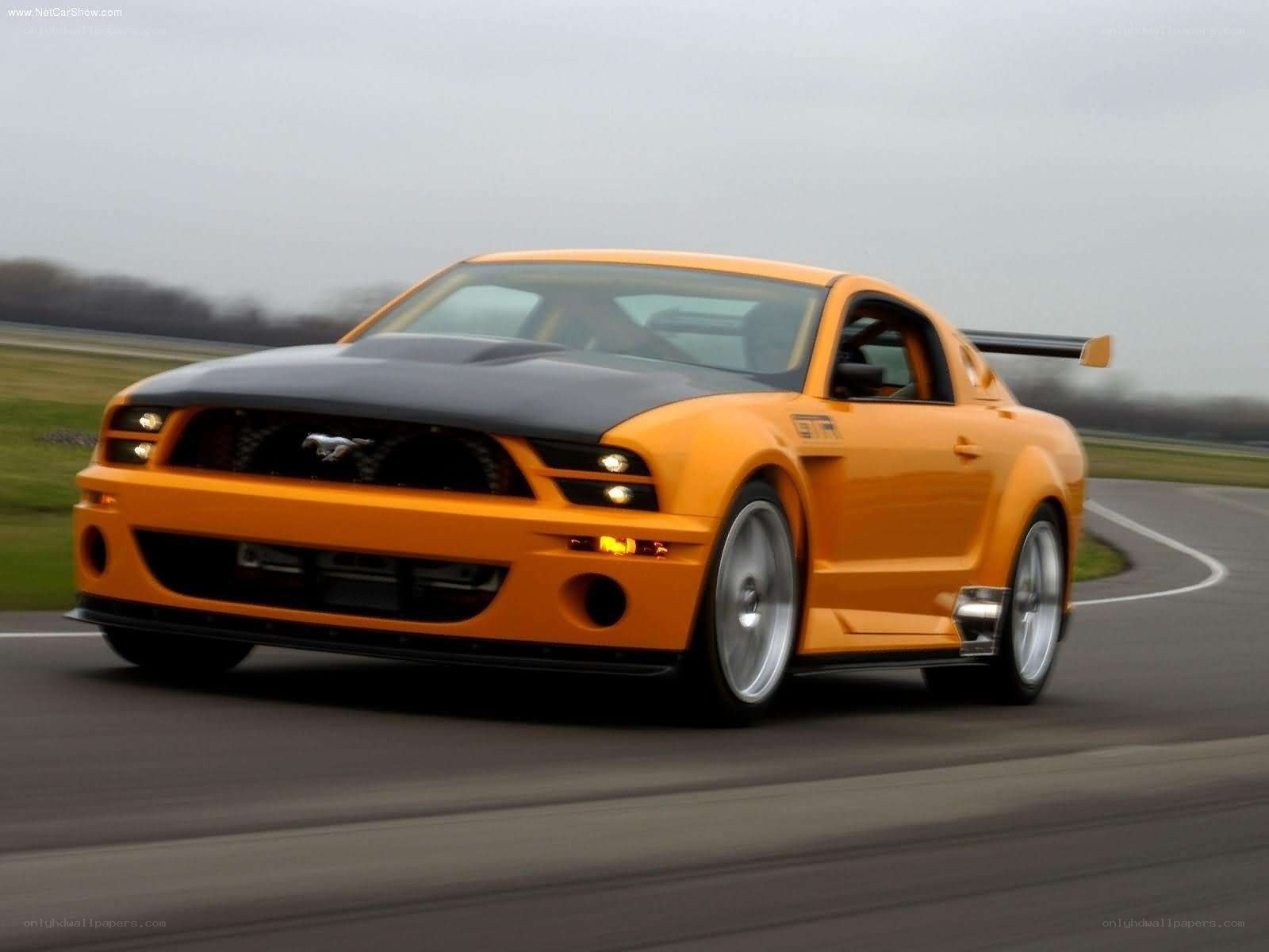 orange mustang on racetrack
