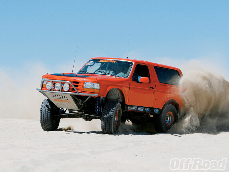 Orange off-road truck in sand