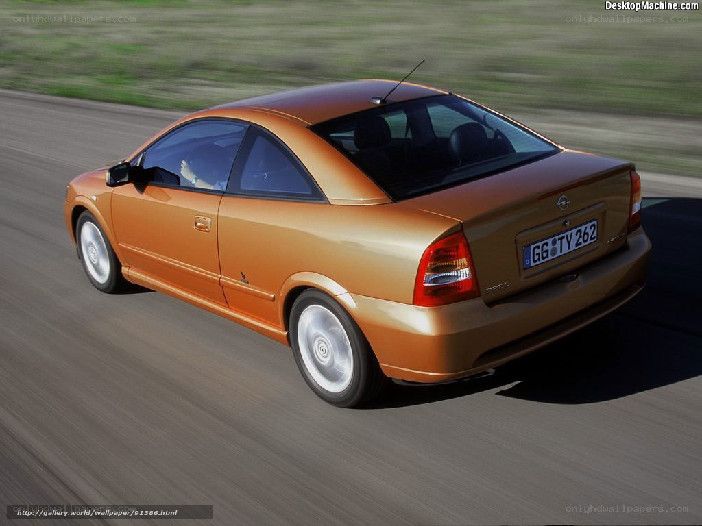 orange opel astra coupe in motion