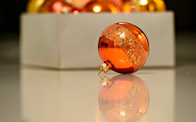 Orange ornament on reflective surface