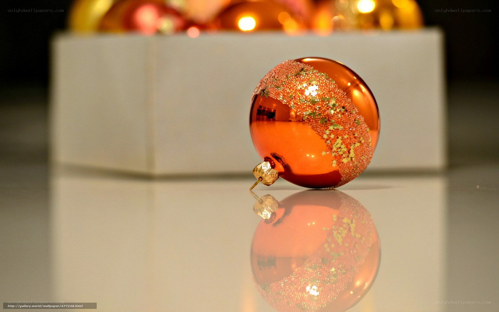 Orange ornament on reflective surface