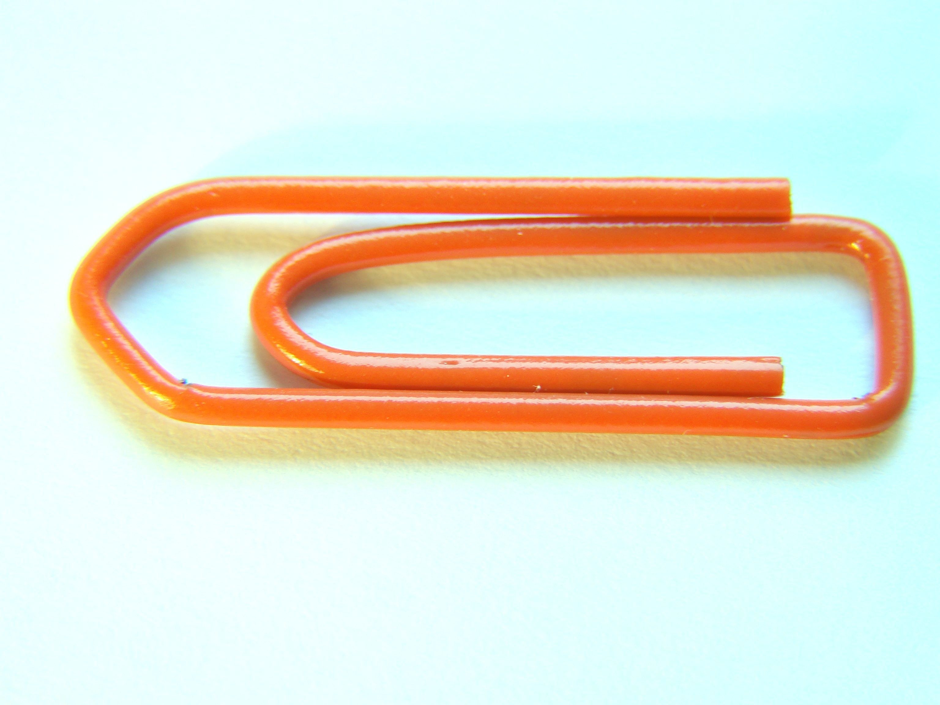 orange paperclip on white